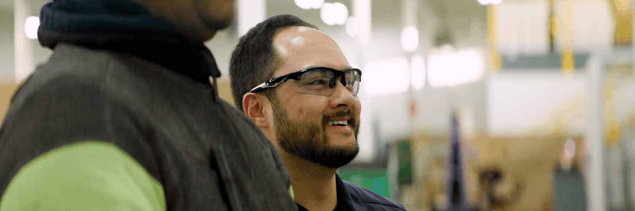 Cardinal CLiC employee smiling with another employee