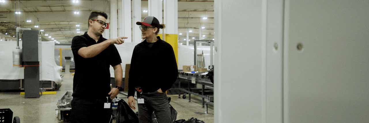 Two Cardinal employees working together Two Cardinal employees working together